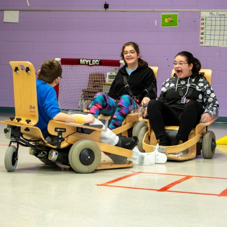 Three children playing volt hockey